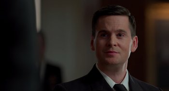 Movie still from “The Caine Mutiny Court-Martial” (2023), directed by William Friedkin – A person wearing a suit and tie; Close Up shot, Over the shoulder angle