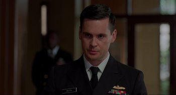 Movie still from “The Caine Mutiny Court-Martial” (2023), directed by William Friedkin – A person wearing a suit and tie; Close Up shot, Over the shoulder angle