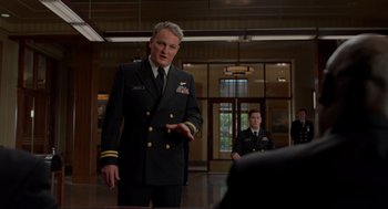 Movie still from “The Caine Mutiny Court-Martial” (2023), directed by William Friedkin – A man in a military uniform standing in front of another man; Medium shot, Low angle