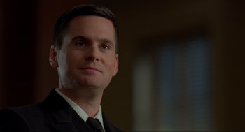 Movie still from “The Caine Mutiny Court-Martial” (2023), directed by William Friedkin – A person wearing a suit and tie; Close Up shot, Low angle