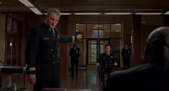 Movie still from “The Caine Mutiny Court-Martial” (2023), directed by William Friedkin – A group of men in uniforms in a room; Medium shot, Low angle