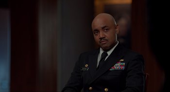 Movie still from “The Caine Mutiny Court-Martial” (2023), directed by William Friedkin – A man in a military uniform sitting in a room; Close Up shot, Over the shoulder angle