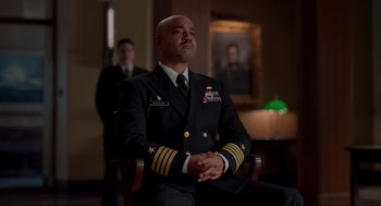 Movie still from “The Caine Mutiny Court-Martial” (2023), directed by William Friedkin – A man in a military uniform sitting in a chair; Medium shot, Low angle