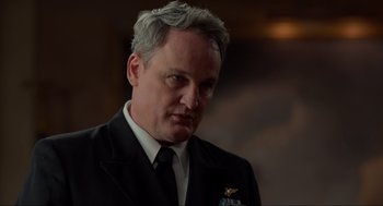 Movie still from “The Caine Mutiny Court-Martial” (2023), directed by William Friedkin – A person wearing a suit and tie; Close Up shot, Over the shoulder angle