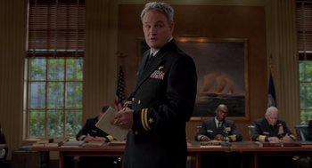 Movie still from “The Caine Mutiny Court-Martial” (2023), directed by William Friedkin – A man in a military uniform stands in front of other men; Medium shot, Low angle