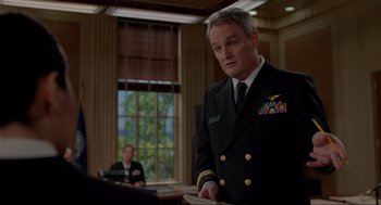 Movie still from “The Caine Mutiny Court-Martial” (2023), directed by William Friedkin – A man in a military uniform stands in front of another man; Medium shot, Low angle