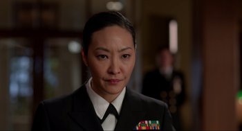 Movie still from “The Caine Mutiny Court-Martial” (2023), directed by William Friedkin – A woman in a military uniform is looking at the camera; Close Up shot, Over the shoulder angle