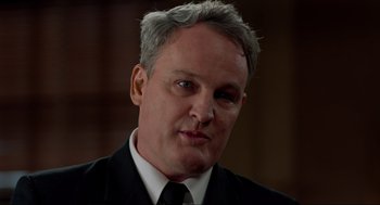 Movie still from “The Caine Mutiny Court-Martial” (2023), directed by William Friedkin – A person wearing a suit and tie; Close Up shot, Low angle