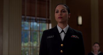 Movie still from “The Caine Mutiny Court-Martial” (2023), directed by William Friedkin – A woman in a military uniform standing in front of a window; Close Up shot, Low angle