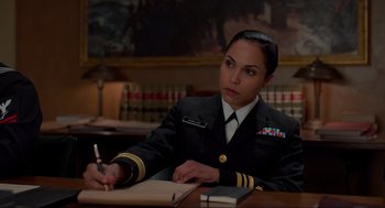 Movie still from “The Caine Mutiny Court-Martial” (2023), directed by William Friedkin – A woman in a military uniform writing on a piece of paper; Medium shot, Over the shoulder angle