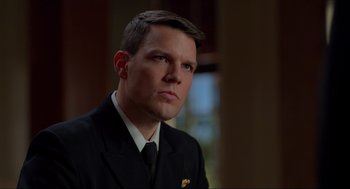 Movie still from “The Caine Mutiny Court-Martial” (2023), directed by William Friedkin – A person wearing a suit and tie; Close Up shot, Over the shoulder angle