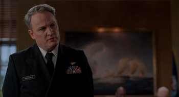 Movie still from “The Caine Mutiny Court-Martial” (2023), directed by William Friedkin – A person wearing a suit and tie; Close Up shot, Low angle