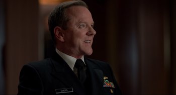 Movie still from “The Caine Mutiny Court-Martial” (2023), directed by William Friedkin – A person wearing a suit and tie; Close Up shot, Over the shoulder angle