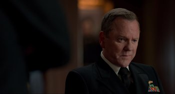 Movie still from “The Caine Mutiny Court-Martial” (2023), directed by William Friedkin – A person wearing a suit and tie; Close Up shot, Over the shoulder angle