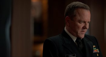 Movie still from “The Caine Mutiny Court-Martial” (2023), directed by William Friedkin – A person wearing a suit and tie; Close Up shot, Over the shoulder angle