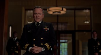 Movie still from “The Caine Mutiny Court-Martial” (2023), directed by William Friedkin – A man in a military uniform sitting in a chair; Close Up shot, Over the shoulder angle