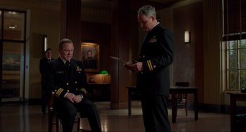 Movie still from “The Caine Mutiny Court-Martial” (2023), directed by William Friedkin – Two men in uniforms are holding a knife; Medium shot, Low angle