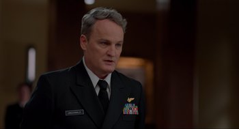 Movie still from “The Caine Mutiny Court-Martial” (2023), directed by William Friedkin – A person wearing a suit and tie; Close Up shot, Low angle