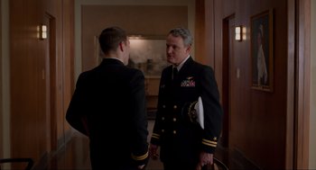 Movie still from “The Caine Mutiny Court-Martial” (2023), directed by William Friedkin – Two men in military uniforms talking to each other; Medium shot, Over the shoulder angle