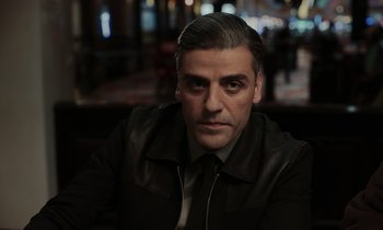 Movie still from “The Card Counter” (2021), directed by Paul Schrader – A person wearing a suit and tie; Close Up shot, Over the shoulder angle