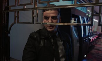 Movie still from “The Card Counter” (2021), directed by Paul Schrader – A man wearing a leather jacket looking into a mirror; Medium shot, Low angle