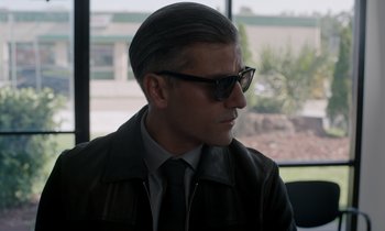 Movie still from “The Card Counter” (2021), directed by Paul Schrader – A person wearing a suit and sunglasses; Close Up shot, Over the shoulder angle