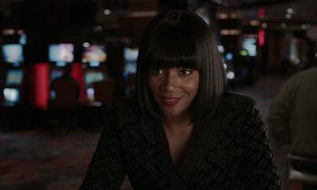 Movie still from “The Card Counter” (2021), directed by Paul Schrader – A woman in a black jacket and a black wig; Close Up shot, Over the shoulder angle