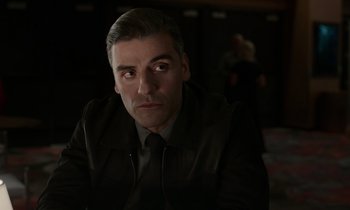 Movie still from “The Card Counter” (2021), directed by Paul Schrader – A person wearing a suit and tie; Close Up shot, Over the shoulder angle