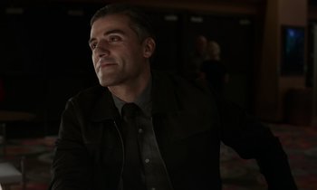 Movie still from “The Card Counter” (2021), directed by Paul Schrader – A person wearing a suit and tie; Close Up shot, Over the shoulder angle