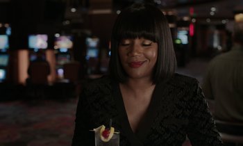 Movie still from “The Card Counter” (2021), directed by Paul Schrader – A woman holding a drink in front of a slot machine; Close Up shot, Over the shoulder angle