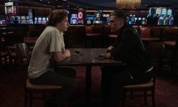 Movie still from “The Card Counter” (2021), directed by Paul Schrader – Two people sitting at a table in a restaurant; Medium shot, Over the shoulder angle