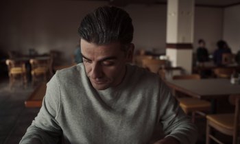 Movie still from “The Card Counter” (2021), directed by Paul Schrader – A person sitting at a table; Close Up shot, Low angle
