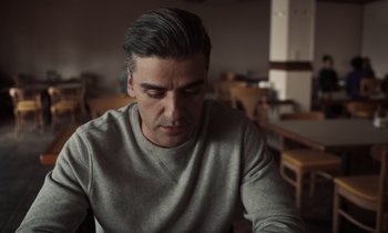 Movie still from “The Card Counter” (2021), directed by Paul Schrader – A person sitting at a table; Close Up shot, Over the shoulder angle