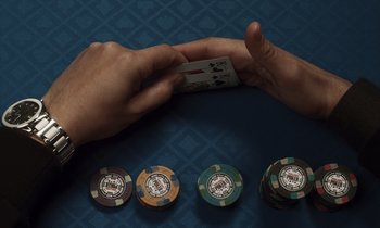 Movie still from “The Card Counter” (2021), directed by Paul Schrader – A person is holding a deck of playing cards; Extreme Close Up shot, Overhead angle