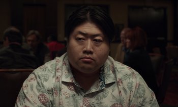 Movie still from “The Card Counter” (2021), directed by Paul Schrader – A person wearing a floral shirt; Close Up shot, Low angle