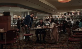 Movie still from “The Card Counter” (2021), directed by Paul Schrader – A group of people sitting at a table in a restaurant; Wide shot, High angle