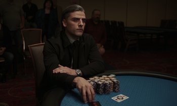 Movie still from “The Card Counter” (2021), directed by Paul Schrader – A man sitting at a table with a lot of poker chips in front of him; Close Up shot, Over the shoulder angle