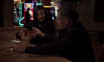 Movie still from “The Card Counter” (2021), directed by Paul Schrader – A man and a woman sitting at a table with drinks in front of them; Medium shot, Over the shoulder angle