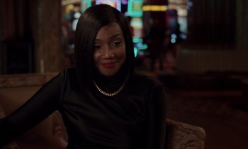 Movie still from “The Card Counter” (2021), directed by Paul Schrader – A woman sitting on a couch in a room; Close Up shot, Over the shoulder angle