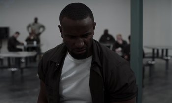 Movie still from “The Card Counter” (2021), directed by Paul Schrader – A man with a beard is looking down at his face; Close Up shot, Low angle