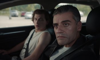 Movie still from “The Card Counter” (2021), directed by Paul Schrader – A man sitting next to another man in the back of a car; Close Up shot, Over the shoulder angle