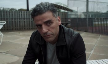 Movie still from “The Card Counter” (2021), directed by Paul Schrader – A person wearing a leather jacket; Close Up shot, Over the shoulder angle