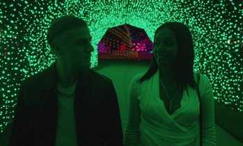 Movie still from “The Card Counter” (2021), directed by Paul Schrader – A man and a woman standing next to each other; Medium shot, Low angle