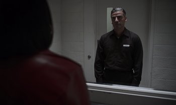 Movie still from “The Card Counter” (2021), directed by Paul Schrader – A man standing in front of a mirror in a room; Medium shot, Over the shoulder angle
