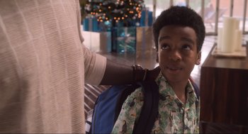 Movie still from “The Christmas Chronicles: Part Two” (2020), directed by Chris Columbus – A man is helping a young boy with a backpack; Close Up shot, Over the shoulder angle
