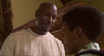 Movie still from “The Christmas Chronicles: Part Two” (2020), directed by Chris Columbus – A man standing next to another man in front of a wall; Close Up shot, Over the shoulder angle