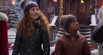 Movie still from “The Christmas Chronicles: Part Two” (2020), directed by Chris Columbus – Two young children wearing winter hats looking up at the sky; Close Up shot, Over the shoulder angle