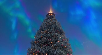 Movie still from “The Christmas Chronicles: Part Two” (2020), directed by Chris Columbus – A large christmas tree with lights on top of it; Extreme Wide shot, Low angle