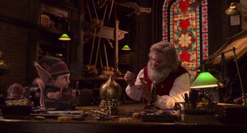 Movie still from “The Christmas Chronicles: Part Two” (2020), directed by Chris Columbus – A man sitting at a table with a child; Medium shot, Over the shoulder angle