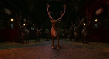 Movie still from “The Christmas Chronicles: Part Two” (2020), directed by Chris Columbus – A herd of deer standing in a barn; Wide shot, Low angle